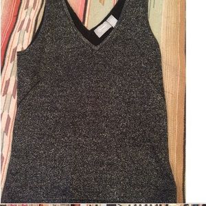 Black and silver sleeveless sweater.